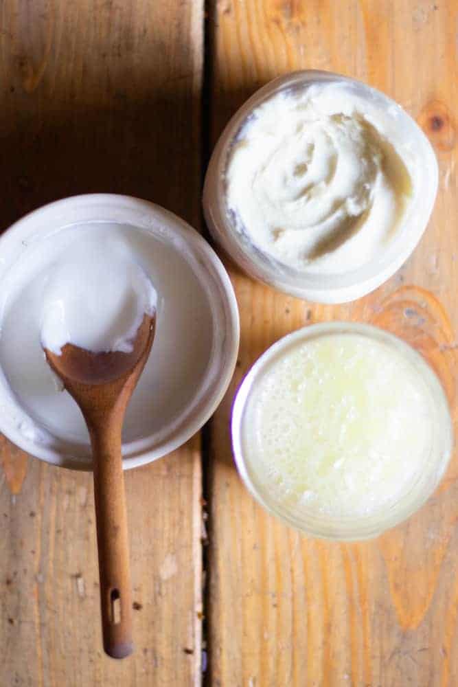 Overhead shot of 3 open mason jars with lotion, face wash, and a yogurt face mask. 