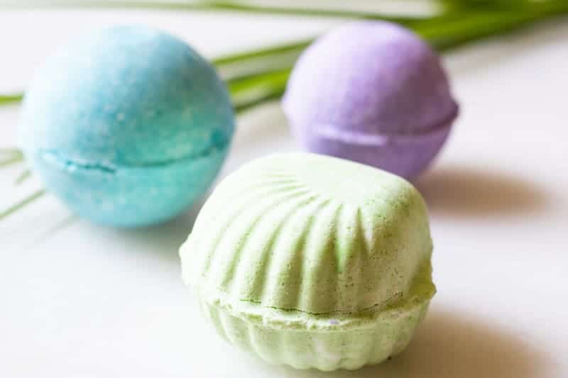 Green, blue, and purple tropical bath bombs shaped as a seashell. 
