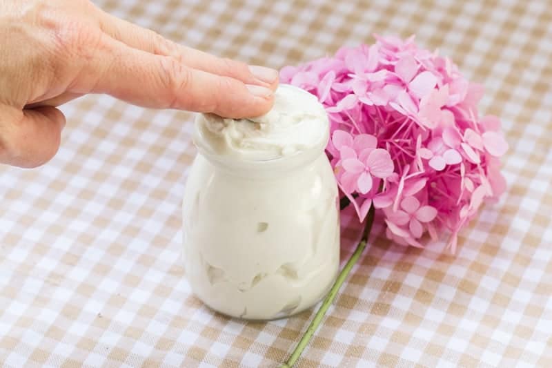Fingers in tallow body butter.
