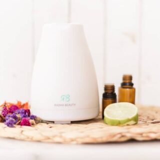 Diffuser with tropical oils and sliced limes.