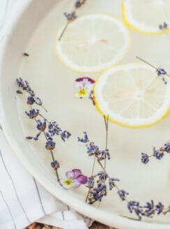 Homemade foot soak with vinegar, lemons, and lavender buds.