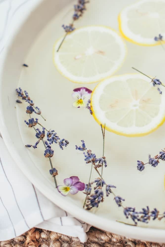 Homemade foot soak with vinegar, lemons, and lavender buds.