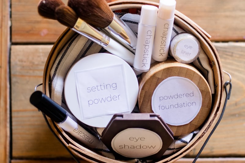 Small basket filled with homemade makeup with labels.