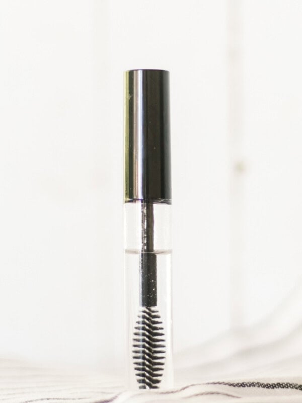 Homemade eyelash serum in a clear bottle.