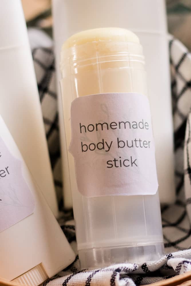 DIY body butter sticks in basket.