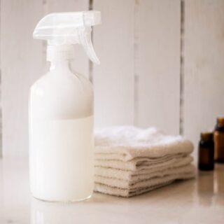 Reusable cleaning wipes spray in a glass bottle.