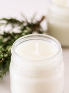 homemade soy candle with rosemary and mint.