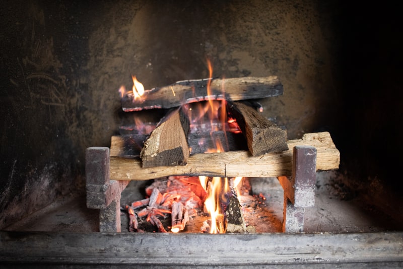 Fire burning in wood burning stove fireplace. 