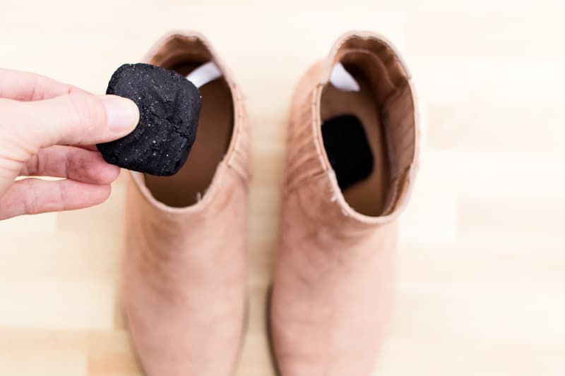 Adding lump charcoal to stinky shoes to absorb the odor.