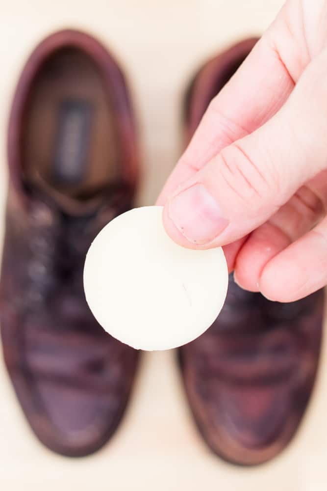 Homemade conditioner bar with leather shoes in background.