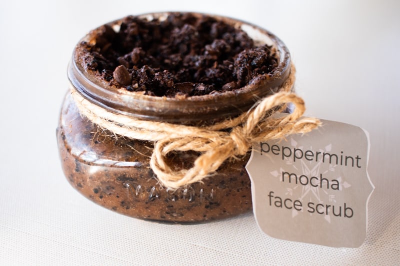 Peppermint mocha homemade face scrub in a decorative shallow glass jar with hemp cord and a recipe card.