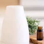 Nebulizer essential oil diffuser on white marble.