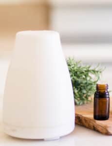 Nebulizer essential oil diffuser on white marble.