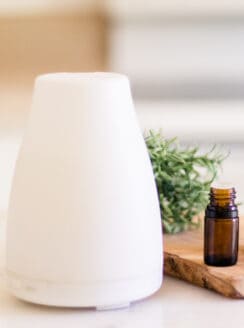 Nebulizer essential oil diffuser on white marble.