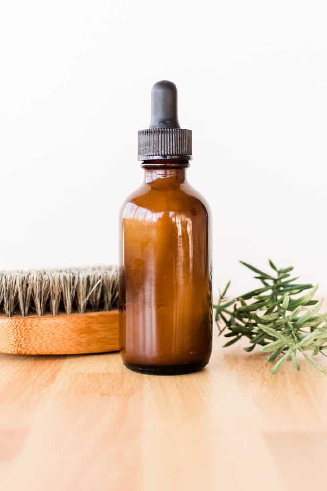 Homemade beard dandruff shampoo in amber colored glass dropper bottle. 