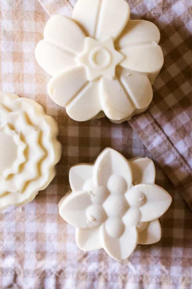 Three flower shaped soap bars made with lard.