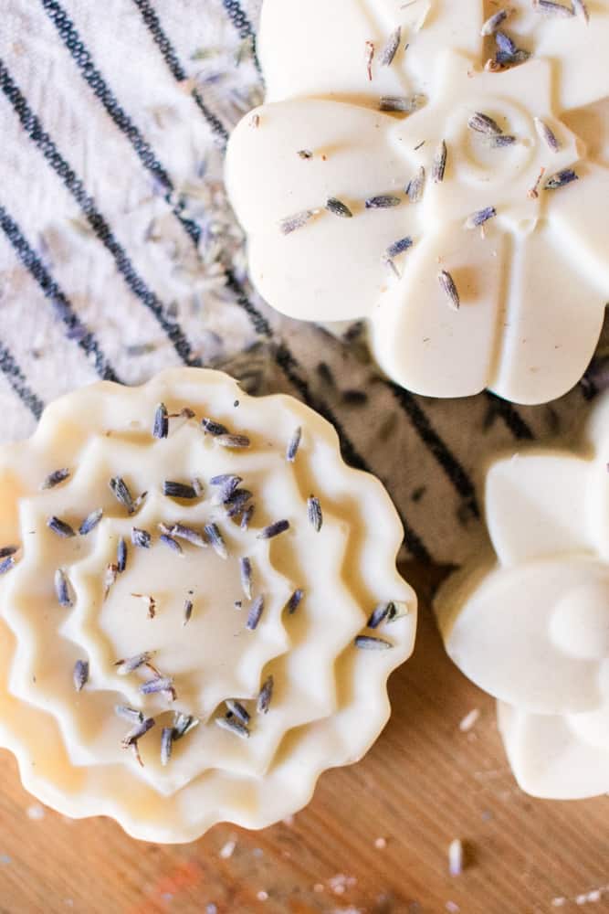 Lavender soap bars on white and black striped tea towel.