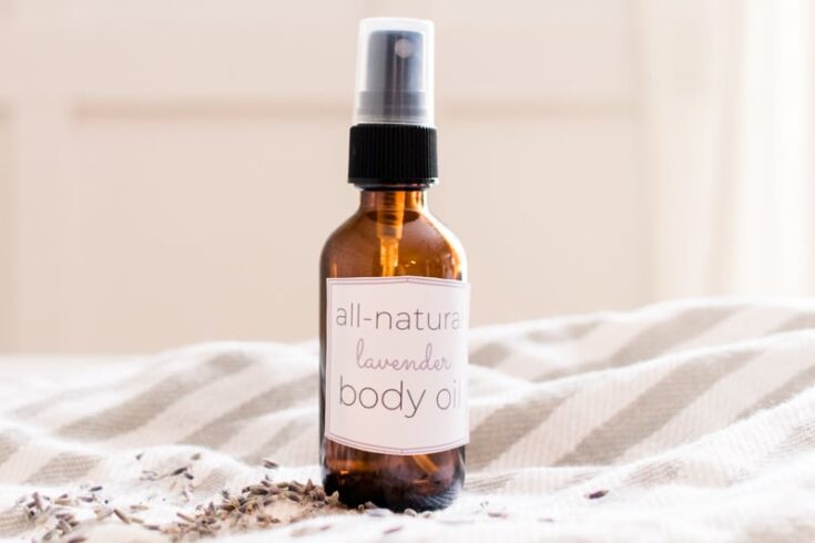 All natural DIY body oil on striped tea towel.