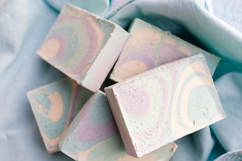 homemade soap bars on light blue tea towel 