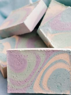 Homemade castile soap bars with decorative swirls.