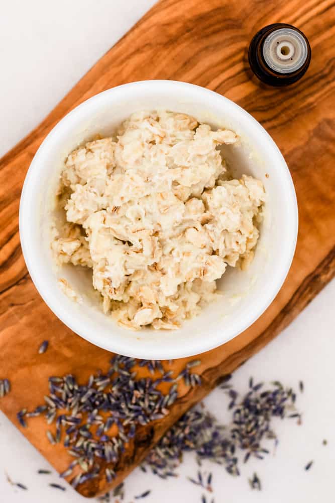 DIY hand mask in small bowl with lavender buds sprinkled around it.