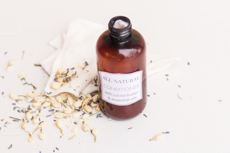 Natural conditioner for hair in small amber colored conditioner bottle.