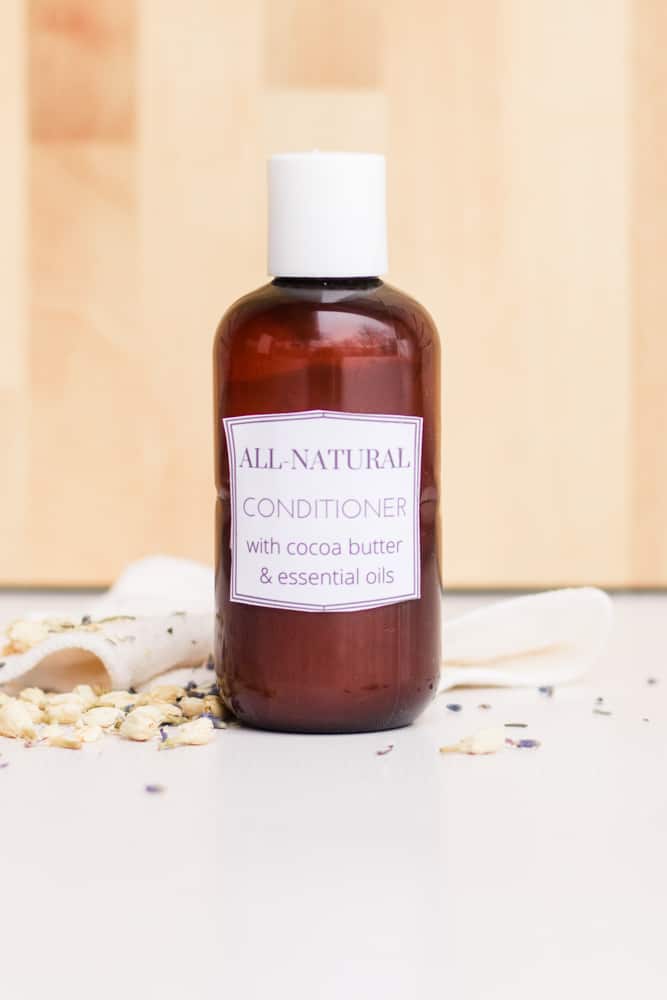 Homemade conditioner in a repurposed conditioner bottle with dried lavender sprigs.