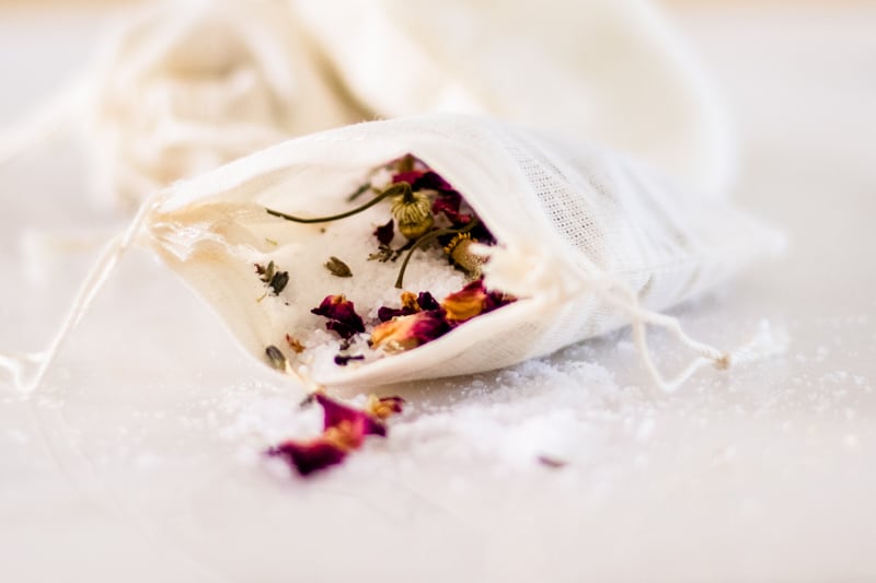 A green tea bath in a small pouch spilling out the top.