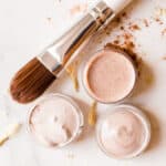Concealer applicator brush with several different concealer shades.