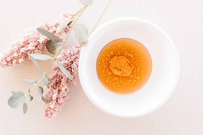 A homemade face mask for instant glowing skin with dried turmeric springs on white vanity.