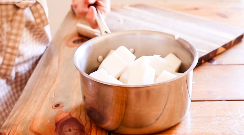 Chunks of melt and pour soap base in a small pot in preparation of melting down.