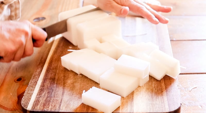 Chopping up a shea butter melt and pour soap base to melt down for soap.