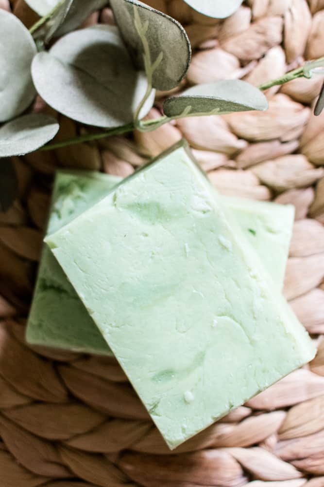 Cooling aloe soap bars on whicker mat with dried leaves.