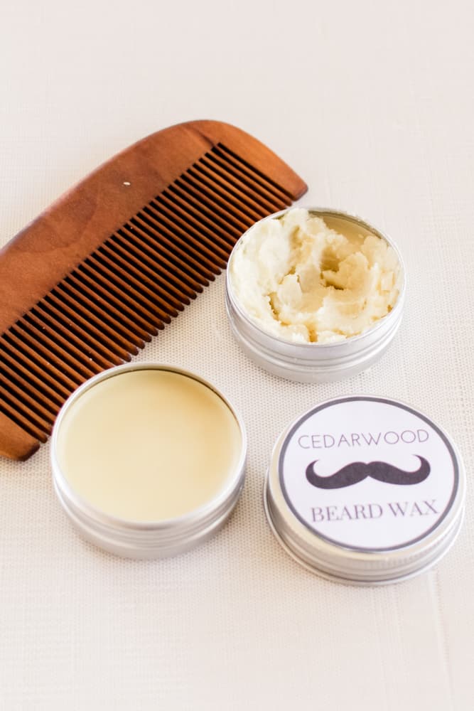 Mustache wax and beard wax in small tins with a wooden bristle beard brush.