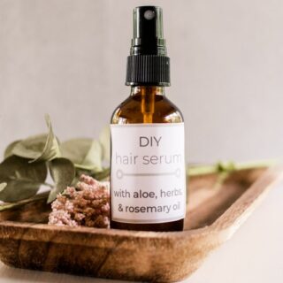 Homemade hair serum with natural ingredients in a glass jar.