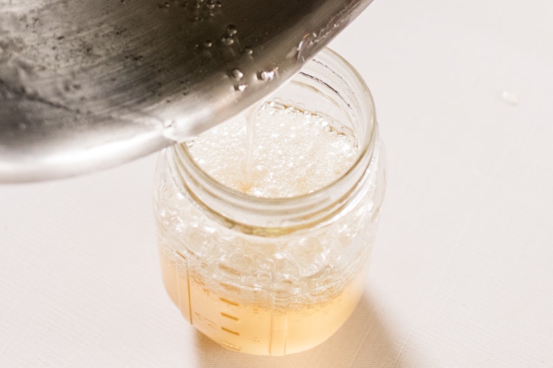 Hot melted sugar wax into a cooling jar.