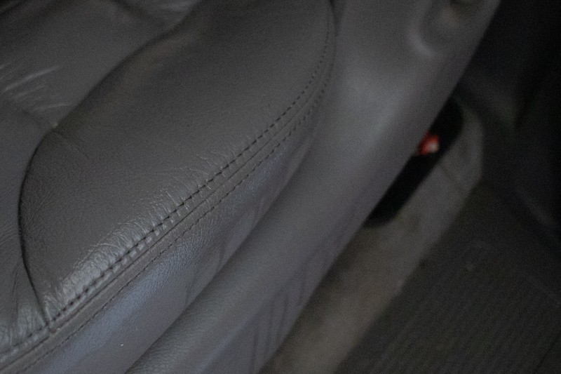 Leather car seat showing no stain after being cleaned.