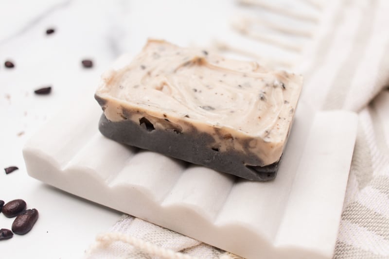 Coffee soap on a white soap dish.