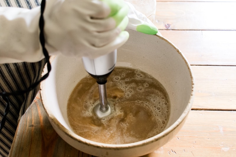 Mixing cold process coffee soap with an immersion blender.