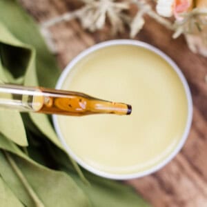 Homemade lemon balm salve in a small metal tin.