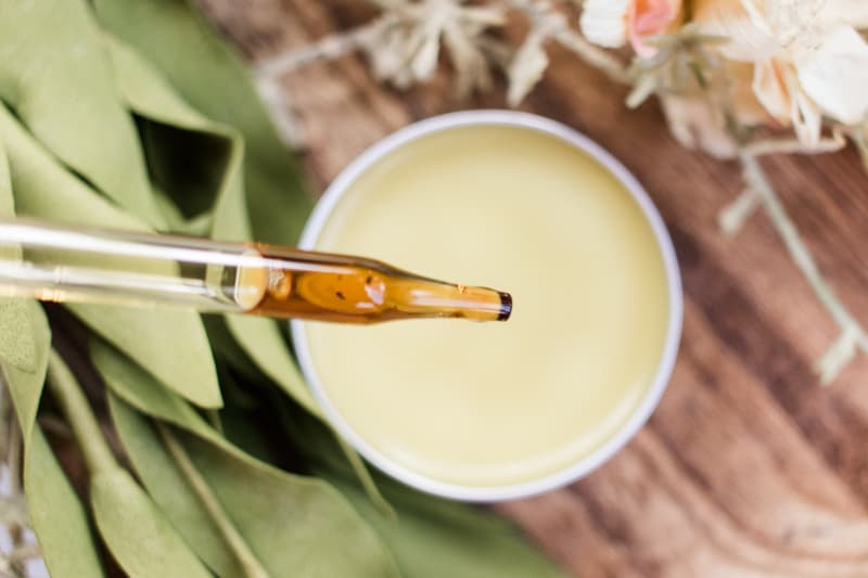 Lemon balm salve close up with dropper bottle. 