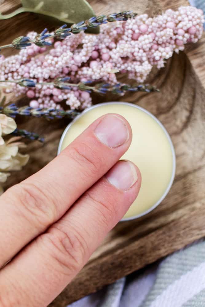 Applying homemade perfume with the fingertips.