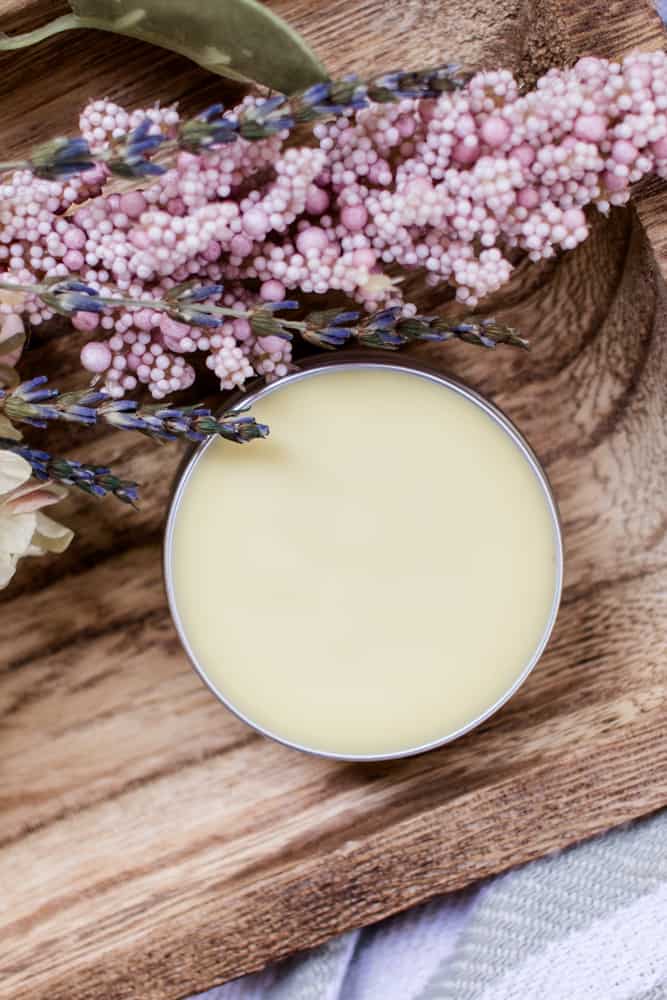 Homemade solid perfume in a small metal storage tin.