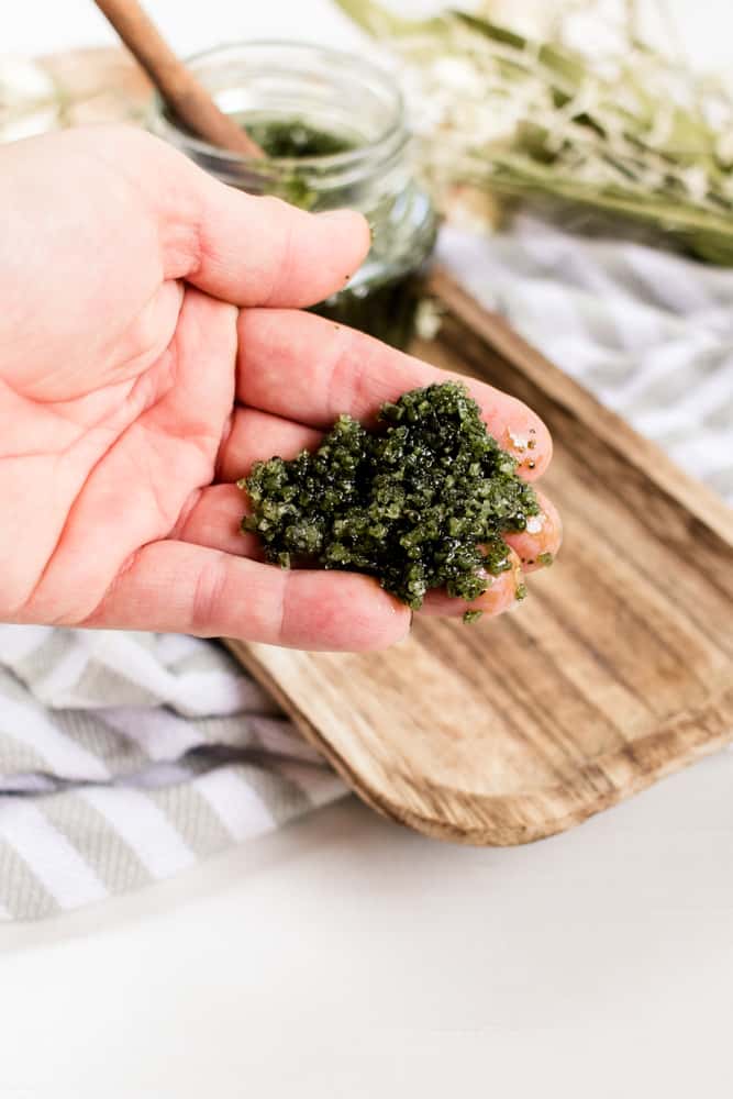 Green tea matcha scrub on a pair of hands. 