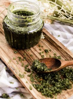 Matcha body scrub on a wooden beauty tray.