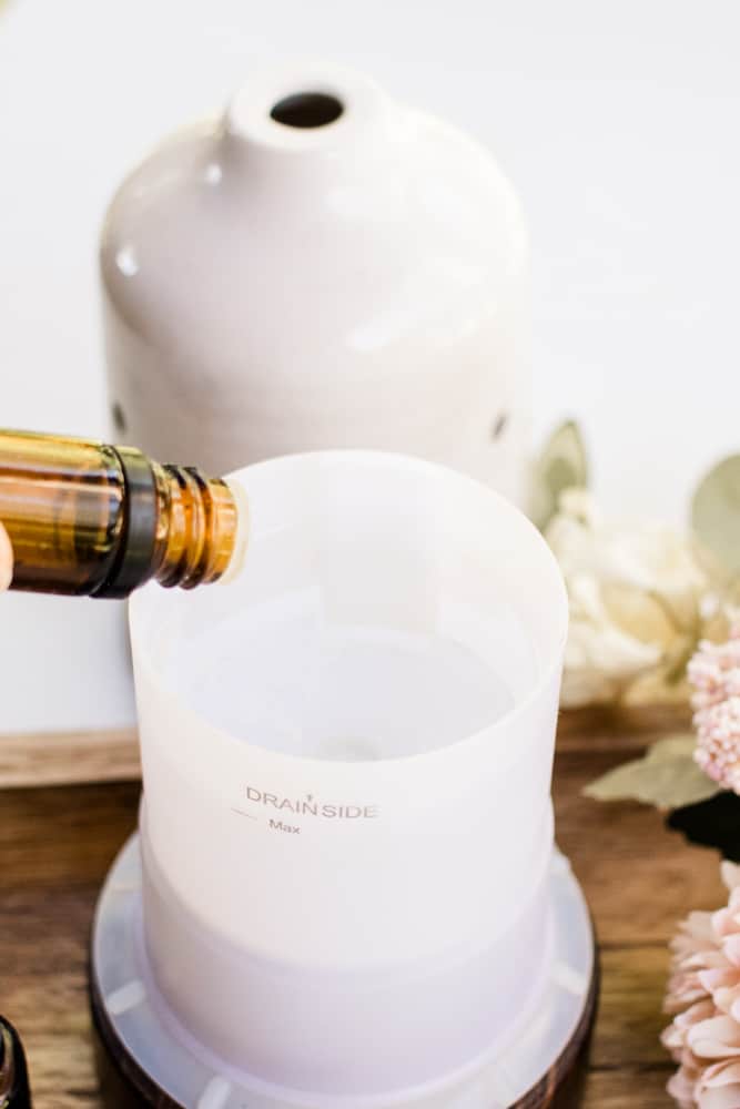 Adding essential oils to a plastic diffuser.