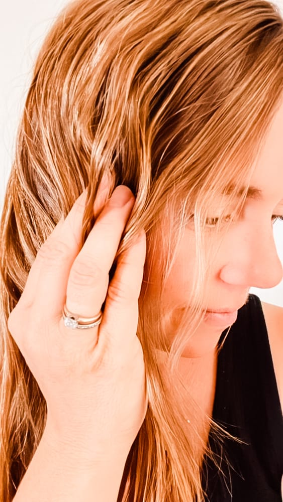 Scrunching hair with curl cream.