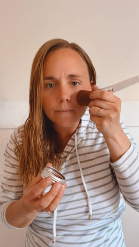 Laura adding diy blush cream to her cheekbones. 