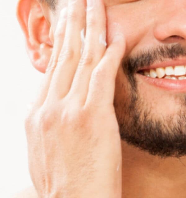 Massaging in aloe to the sides of the face to prevent razor burn.
