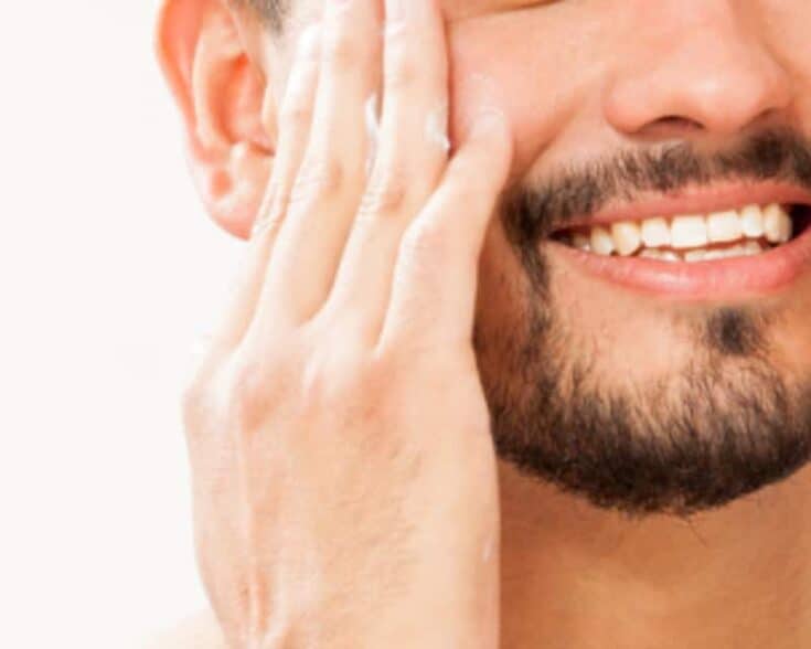 Massaging in aloe to the sides of the face to prevent razor burn.